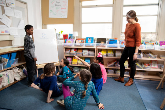 Teacher using whiteboard with students