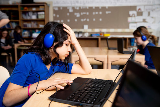 Girl confused by something on laptop computer