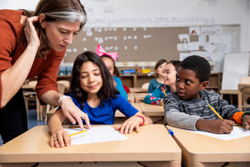 Teacher helping student in class