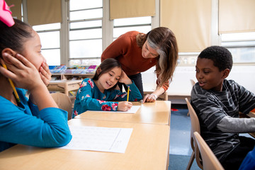 Teacher helping student in class