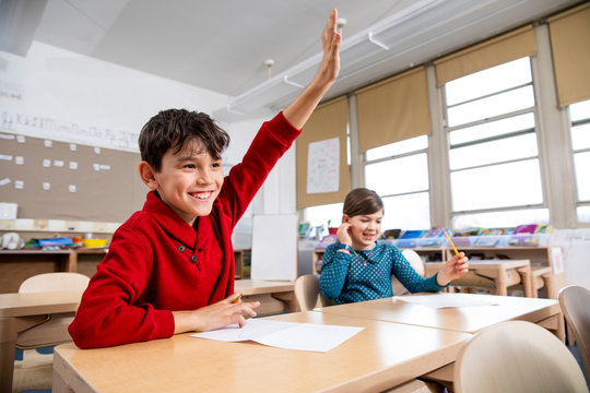 Boy raising hand in class