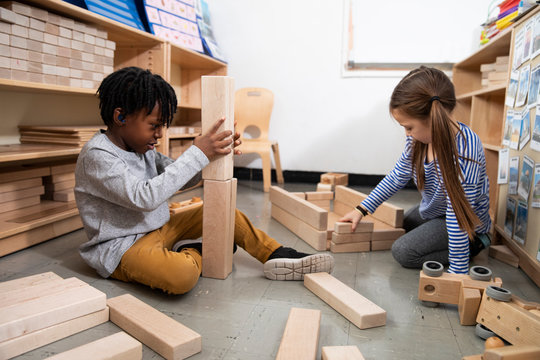 Boy and girl playing with wooden blocks