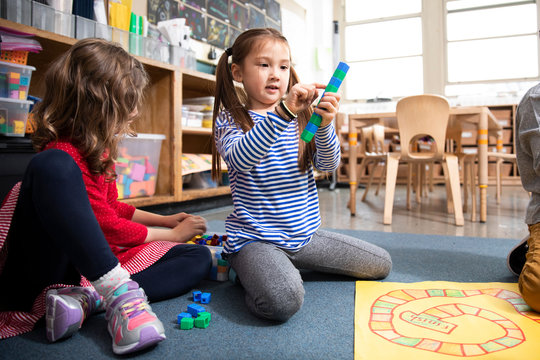 Students playing math game with plastic blocks