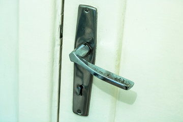 old door handle of an  wooden door with selective focus