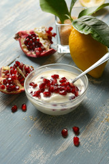 delicious lemon and pomegranate dessert in the glass bowl