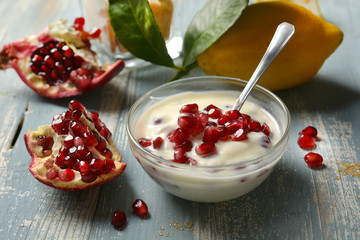 delicious lemon and pomegranate dessert in the glass bowl