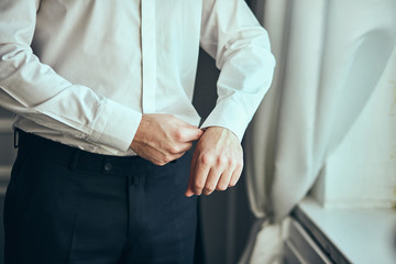 businessman dresses white shirt, male hands closeup,groom getting ready in the morning before wedding ceremony. Men Fashion