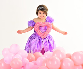 Obraz na płótnie Canvas Valentines day. Childhood happiness. Kid fashion. Little miss in beautiful dress. Childrens day. Small pretty child hold heart. Little girl in princess dress. Party balloons. Happy birthday