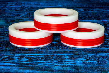 oil seal for hydraulic and pneumatic industrial systems (white and red on a blue background)