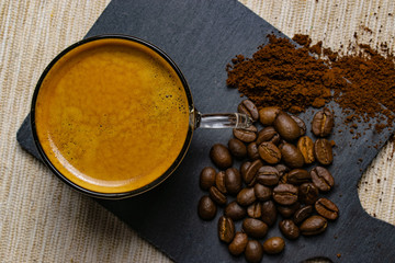 cup of espresso coffee and coffee beans