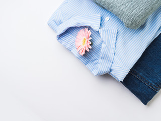 Folded female clothes on white. Fashion flat lay