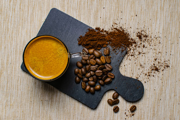 cup of espresso coffee and coffee beans