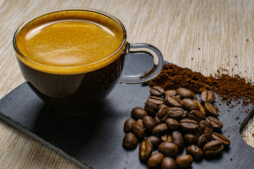 cup of espresso coffee and coffee beans