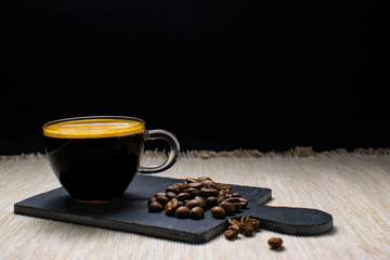 cup of espresso coffee and coffee beans