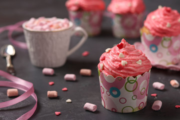 Homemade cupcakes with cream on a dark background. Concept for Valentine's Day, Birthday, March 8 and Mother's  Day
