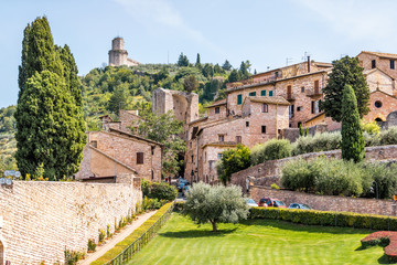 Fototapeta na wymiar Assisi, Italy Giardini di San Francesco or Gardens of Saint Francis near Basilica with green grass lawn and ancient old medieval buildings in summer