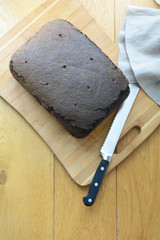 A loaf of rye bread on a wooden cutting board