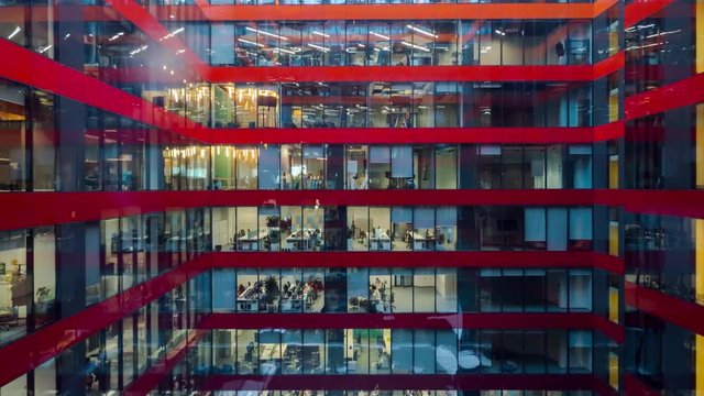 Time lapse of people working in modern office with glass façade