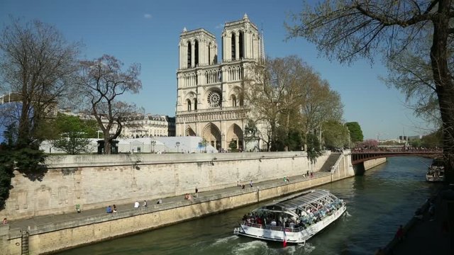 Tour boats pass Notre Dame Cathedral, Paris, France