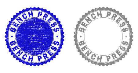 Grunge BENCH PRESS stamp seals isolated on a white background. Rosette seals with grunge texture in blue and gray colors. Vector rubber imprint of BENCH PRESS tag inside round rosette.