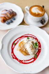 French toast style brioche with vanilla ice cream, pear, nut, mint leaf and red berry sauce. Light morning Breakfast, fresh warm pastries and aromatic cappuccino coffee