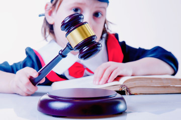 One law for all concept. Portrait of child girl judge (lawyer). Humorous photo.