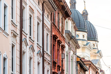 Fototapeta premium Lviv, Ukraine Streetscape side wall pattern in historic Ukrainian Polish Lvov city during day outdoor sunny summer colorful buildings street in old town with church