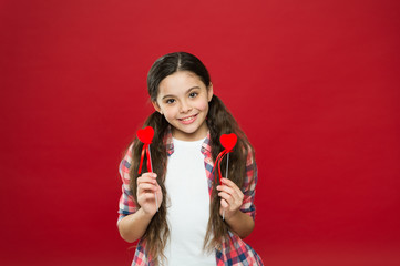 Celebrate valentines day. Fall in love. Love and romantic feelings concept. Red heart attribute of valentine. Heart gift or present. Greeting from sincere heart. Girl child hold heart symbol love