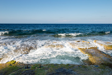 Fototapeta na wymiar seaside baths carved out of rock on the sliema seafront.