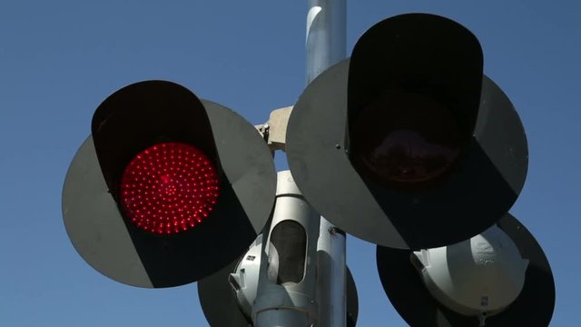 Red lights flash on railroad crossing