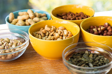 Mixed nuts on wood background 