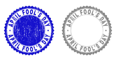 Grunge APRIL FOOL'S DAY stamp seals isolated on a white background. Rosette seals with grunge texture in blue and grey colors. Vector rubber imitation of APRIL FOOL'S DAY label inside round rosette.