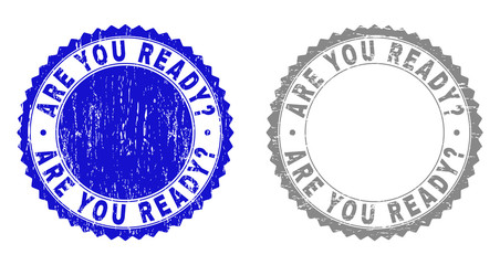 Grunge ARE YOU READY? stamp seals isolated on a white background. Rosette seals with grunge texture in blue and gray colors. Vector rubber imprint of ARE YOU READY? text inside round rosette.