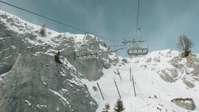 POV perspective view from ski lift travelling uphill to slopes.