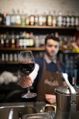 A glass of wine on the background of the bar