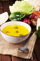 Broth with carrots, onions various fresh vegetables in a pot - colorful fresh clear spring soup. Rural kitchen scenery vegetarian bouillon or stock