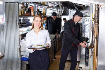Obraz na płótnie Canvas Portrait of waitress at restaurant kitchen