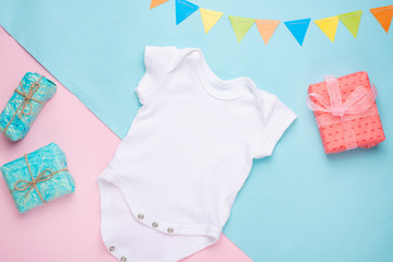 mockup Flat Lay white children shirt with gifts on a colored background. Layout for the design and...