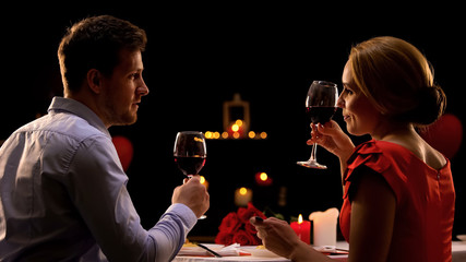 Male and lady having dinner in restaurant tasting red wine, couple on blind date