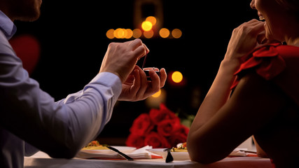 Man proposing beloved lady at romantic dinner in restaurant on st Valentines day