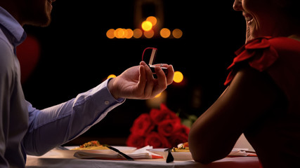 Man making proposal during romantic evening in restaurant, st Valentines Day - obrazy, fototapety, plakaty
