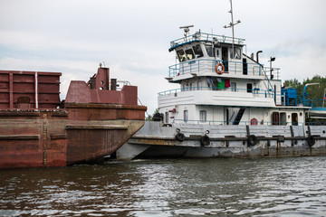 Dry barge floats on a river in the Moscow Region