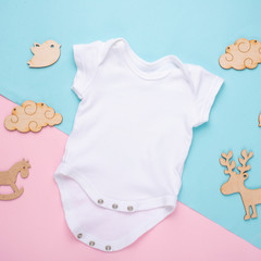 mockup Flat Lay a white children's shirt with wooden toys on a colored background. Layout for the...