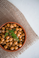 casserole of chick-peas cooked on white fund.boiled chickpeas in a clay pot close up. copy spase.Boiled chickpeas in a bowl.traditional Turkish cuisine