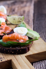 Toasted rye bread with  smoked salmon and fresh green vegetables
