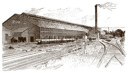 Exterior view of antique factory building with rails, wagons and smoking chimney