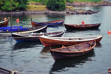 Fototapeta na wymiar Wooden Boats in the Water, in Oslo Norway. 