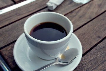 White Cup of Coffee with Spoon and saucer. 