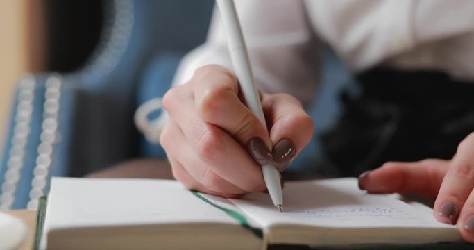 Unrecognizable woman write plan in the daily planner closeup