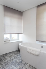 Naklejka na ściany i meble View of a Modern bathroom with white ceramic bath tub
